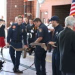 Firefighter Ribbon Cutting with Firehose